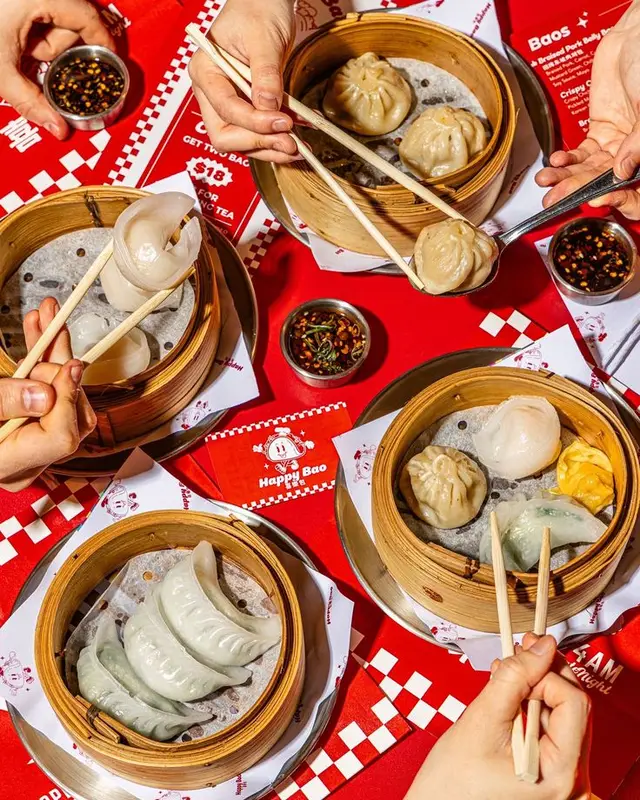Happy Bao dim sum flatlay — bamboo steamers with assorted dumplings