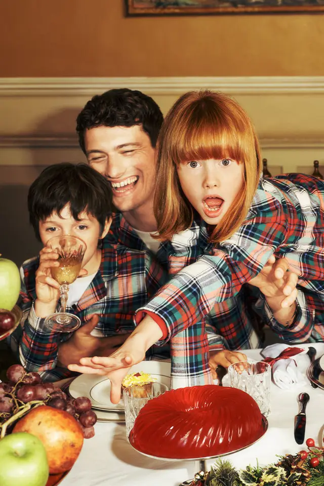 Family Reaching for Red Gelatin Mold at Dinner Table
