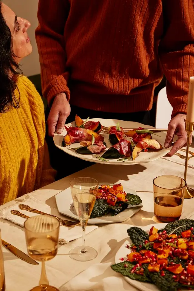 Autumn tablescape with roasted squash, kale and pomegranate