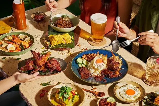 Nasi lemak–style spread with fried chicken, sambal, curry and beer