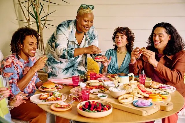 Colorful bagel brunch with friends around a wooden table