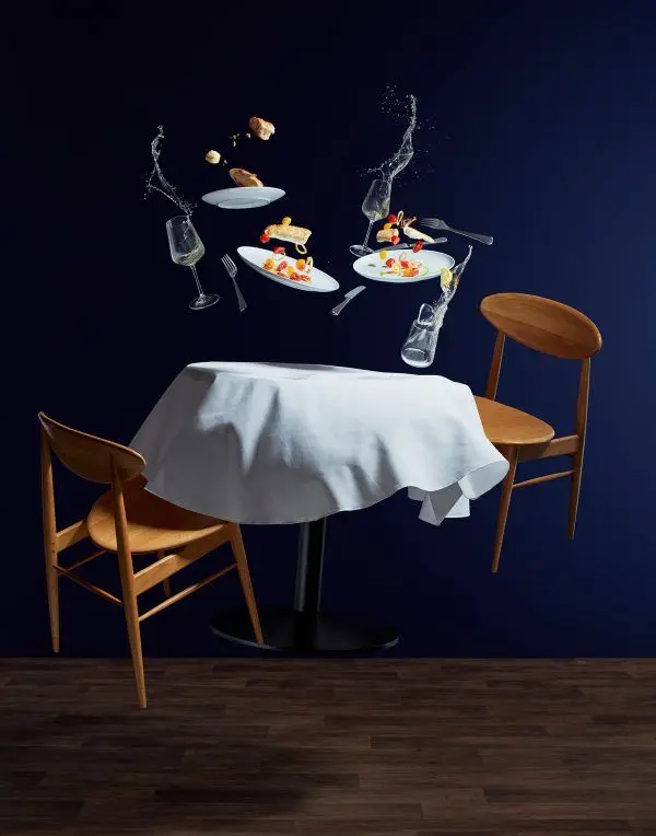 Levitating Dinner: Suspended Plates, Glasses and Cutlery Over White-Tablecloth