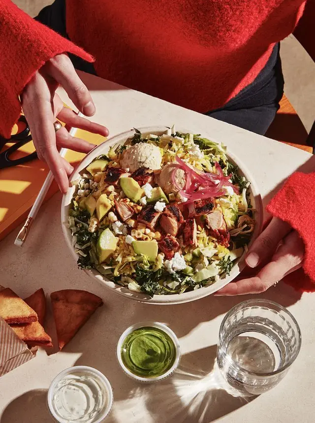 Grilled chicken avocado grain bowl with pickled onions and green sauce