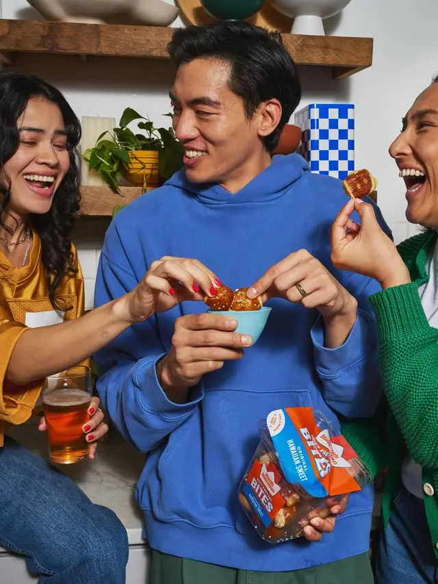 Friends sharing glazed snack bites in kitchen