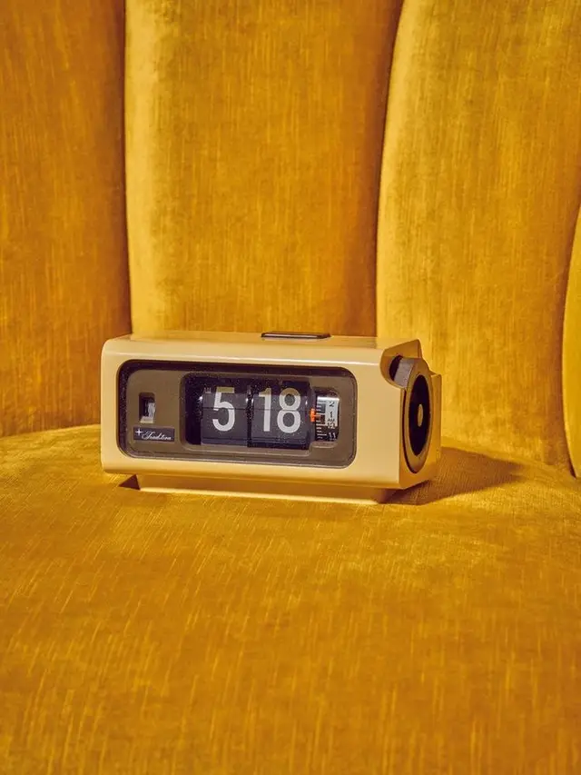 Mustard velvet still life with vintage flip alarm clock