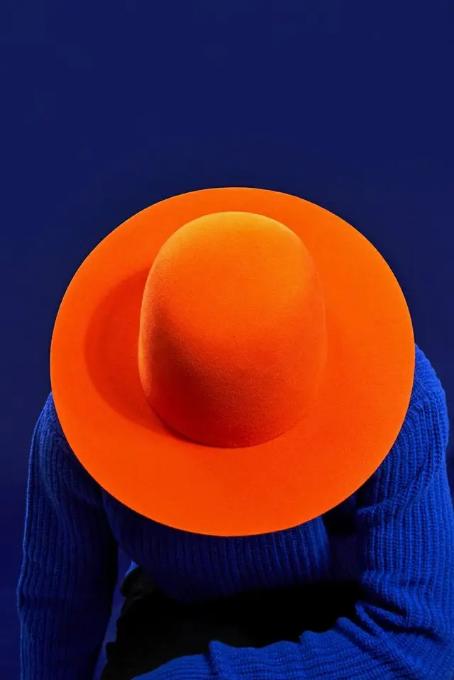 Orange Wide-Brim Felt Hat on Royal Blue Ribbed Sweater — Overhead Fashion Portrait