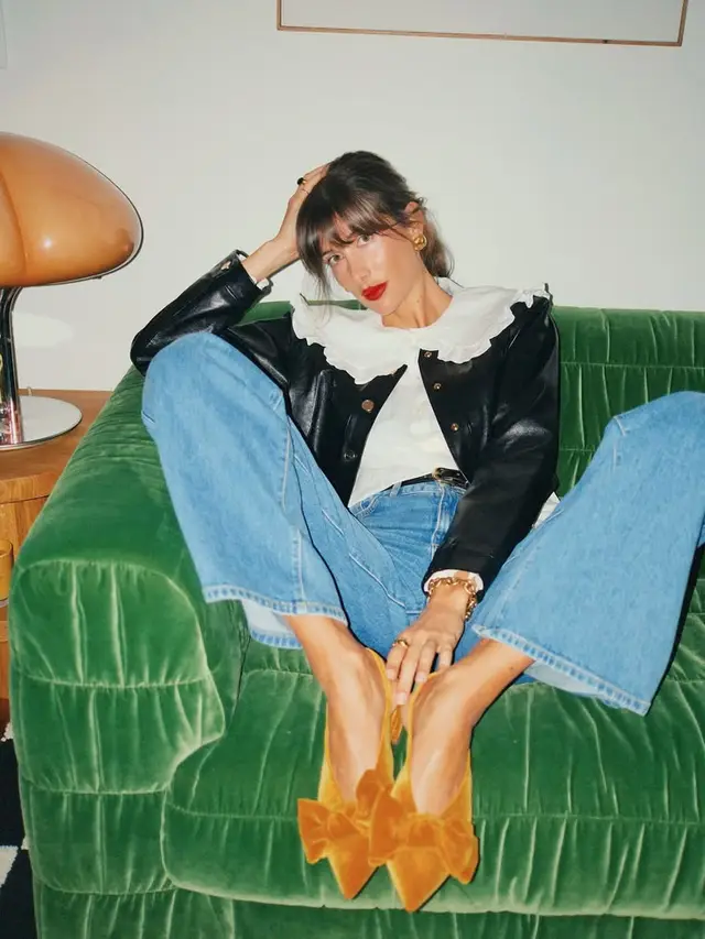 Editorial portrait on green velvet sofa with mustard bow mules