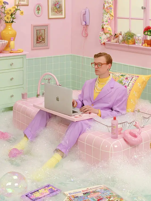 Pastel Retro Bathroom Workspace — Lavender Suit with MacBook on Pink Lap Desk
