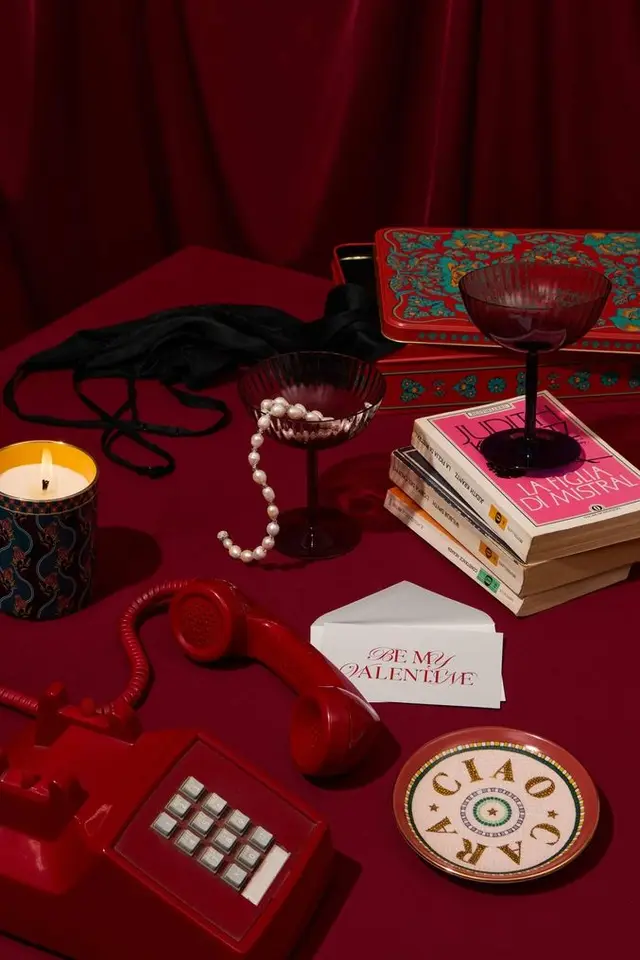 Moody Valentine still life with red telephone, pearls and Italian paperback
