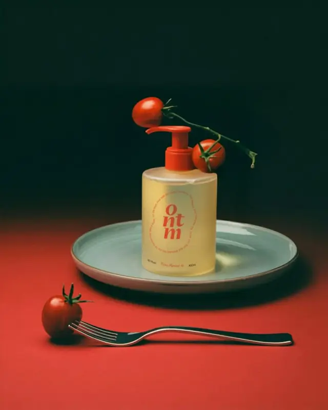 Translucent Pump Dispenser on Ceramic Plate with Vine Tomatoes — Moody Still Life