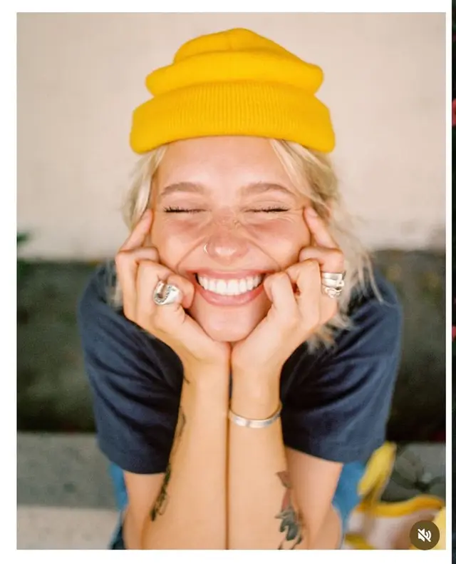 Close-up candid portrait of person in mustard beanie
