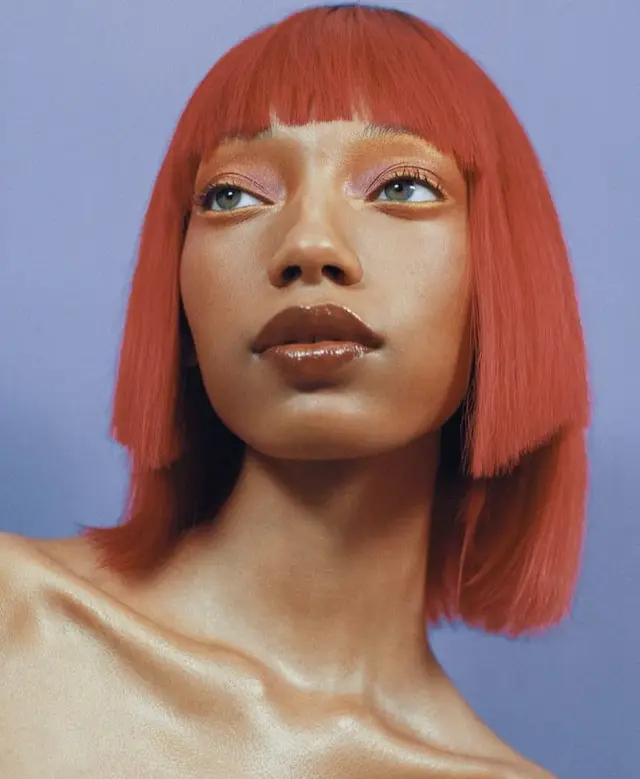 Studio portrait — copper-red blunt bob with glossy lips