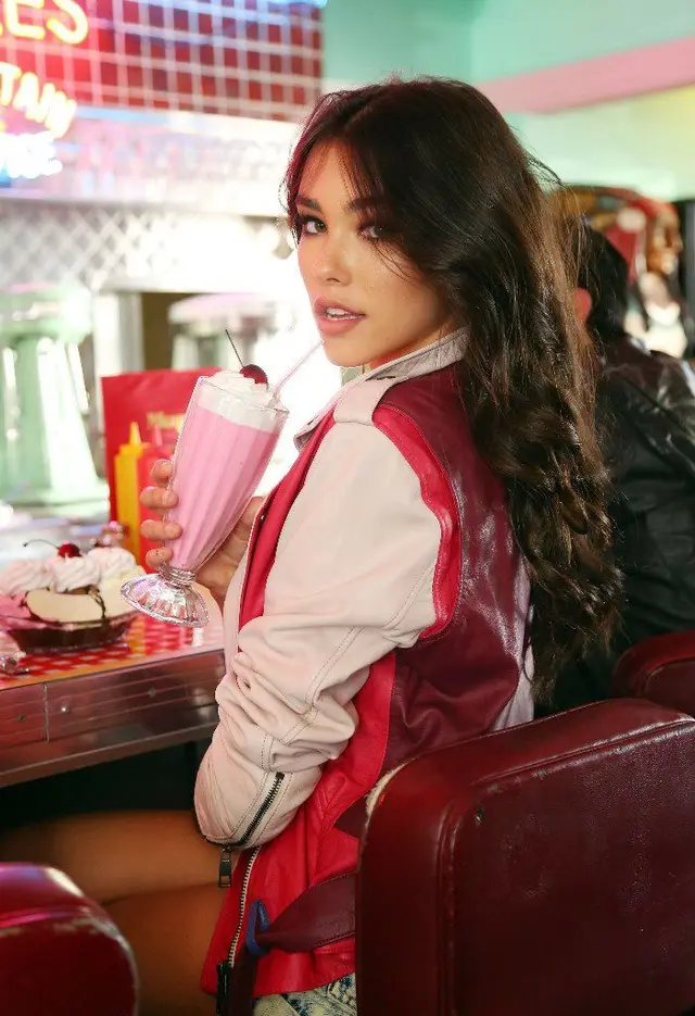 Retro diner portrait — pink milkshake and red leather jacket
