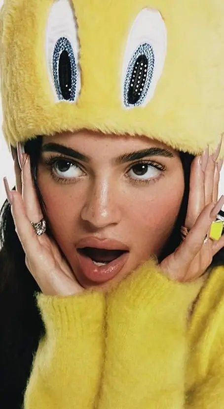 Yellow faux-fur novelty hat with matching fuzzy sweater — editorial close-up