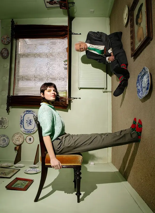 Levitation-style portrait in green parlor with blue-and-white plates