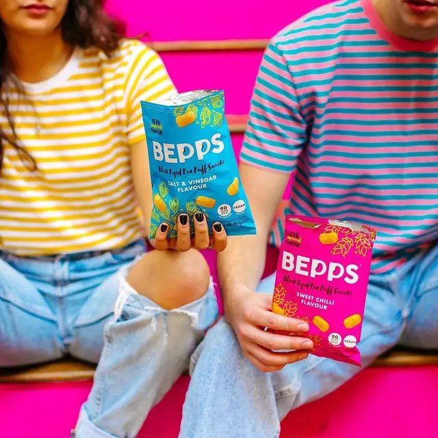 BEPPS snack packaging — turquoise Salt & Vinegar & magenta Sweet Chilli lifestyle shot