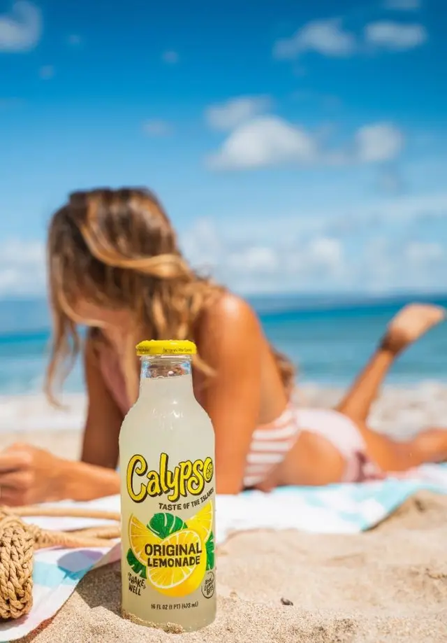 Calypso Original Lemonade bottle on sandy beach
