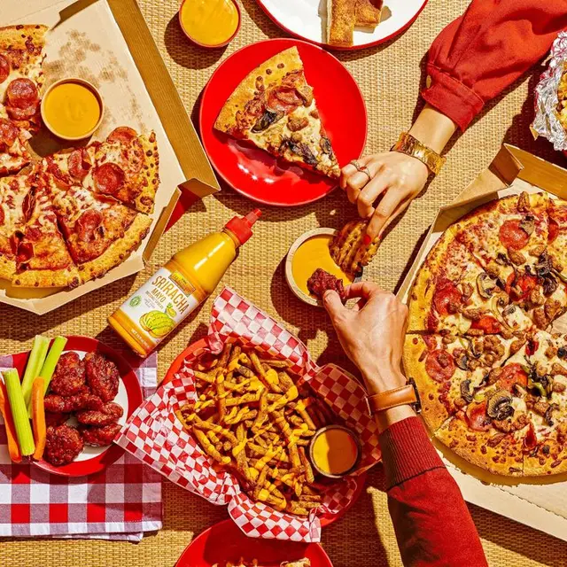 Overhead flat-lay: pepperoni & mushroom pizza party with curly fries and sriracha mayo