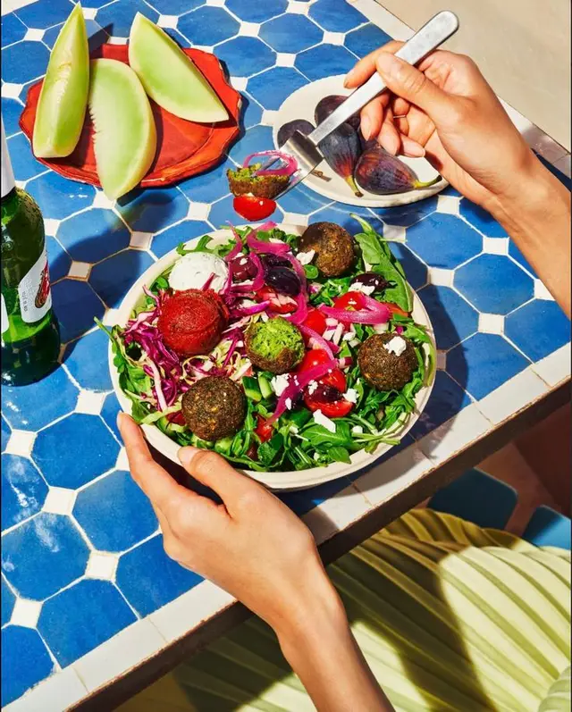 Falafel salad on blue hex-tile table