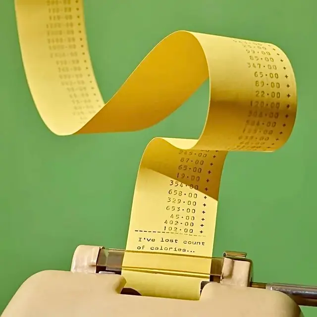 Curled yellow receipt tape from vintage adding machine — "I've lost count of calories"