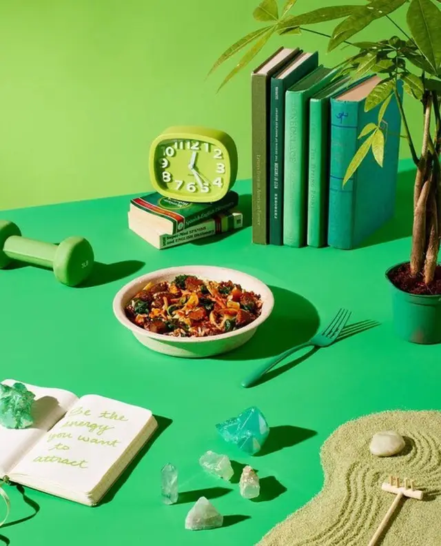 Monochrome Green wellness flatlay with salad, crystals and mini zen garden