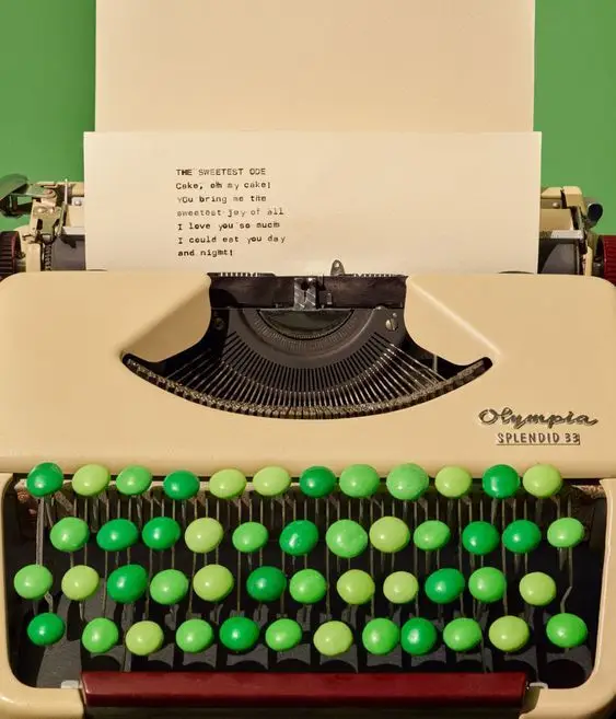 Cream Olympia Splendid 33 typewriter with lime-to-emerald round keytops and typed poem
