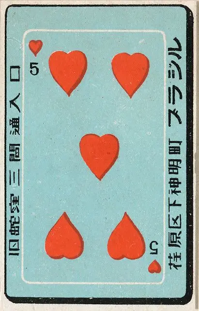 Vintage Japanese Five of Hearts playing card on pale turquoise field