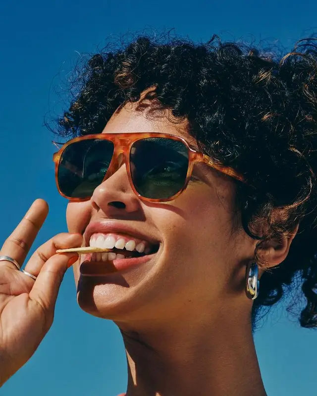 Sunny Close‑Up: Tortoiseshell Sunglasses and Snack