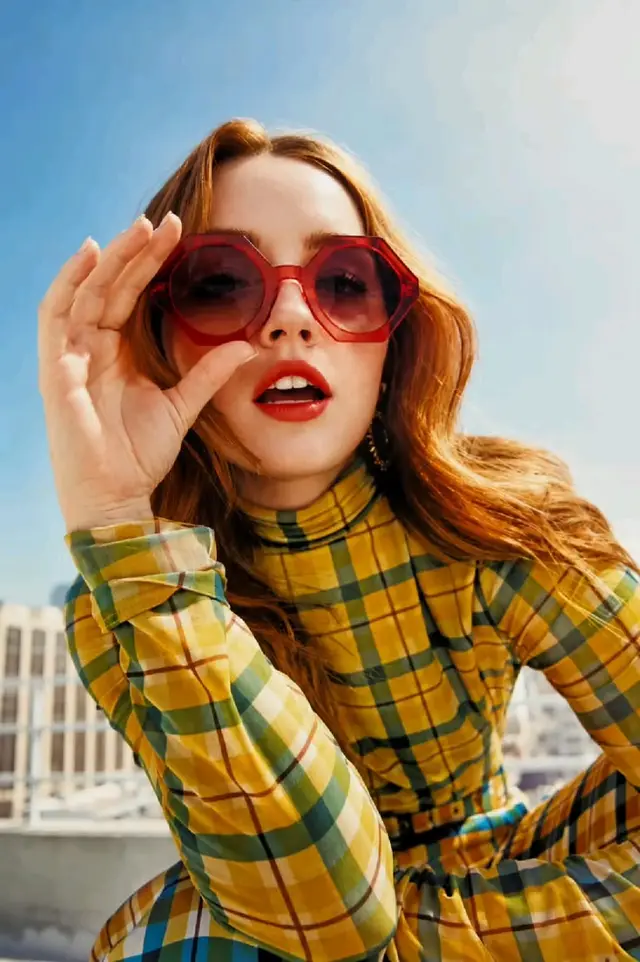 Retro rooftop portrait — yellow-green plaid turtleneck with red octagonal sunglasses